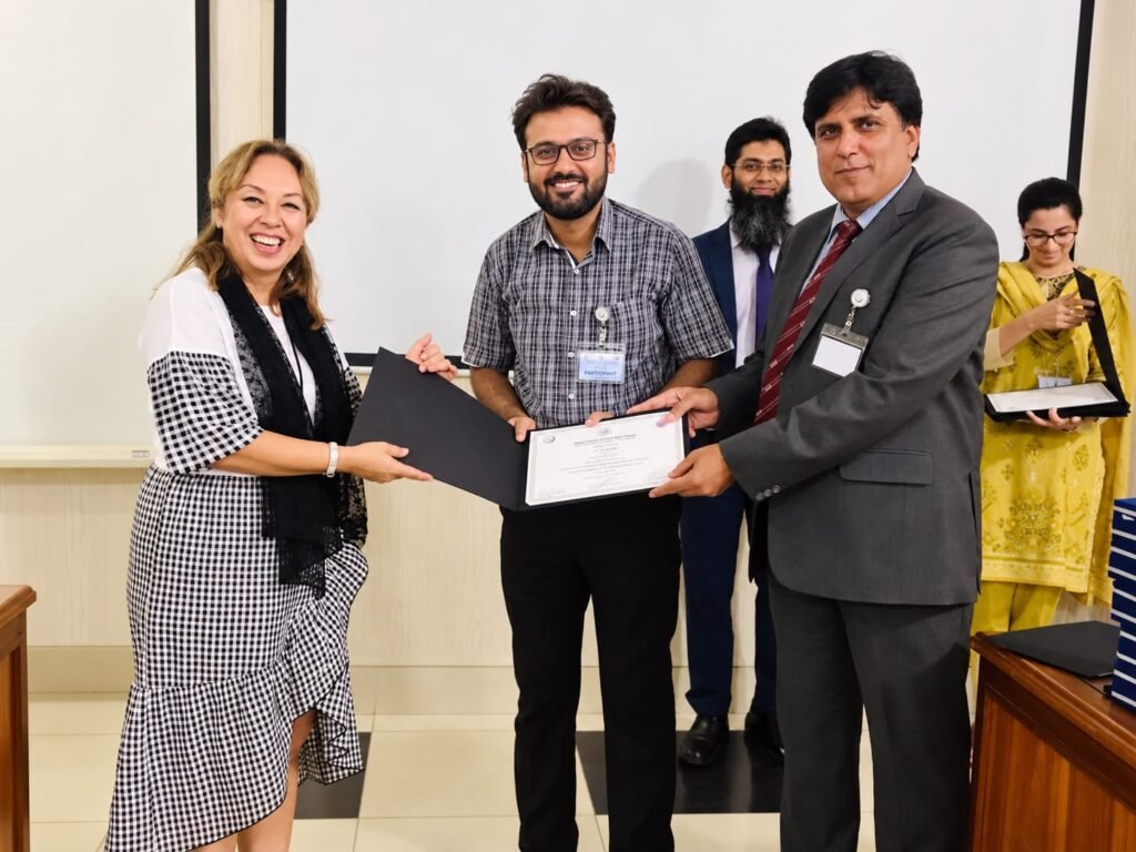Dr. Ali Tahir receiving a certificate from Prof. Dr. Sibel Elif Gultekin